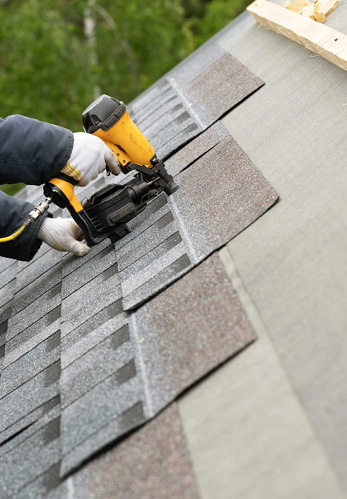 Professional roofing contractor installing high quality asphalt shingles